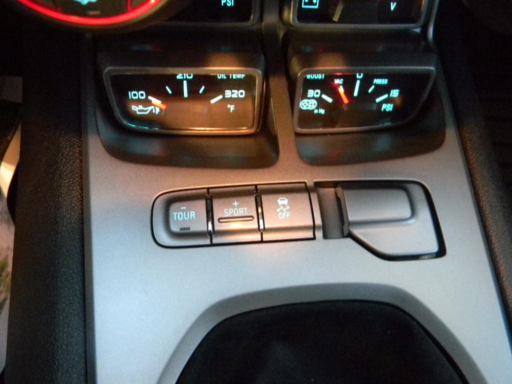 The buttons in the middle allow the driver to choose different driving modes from Sport to touring modes.