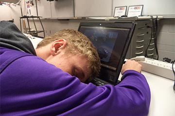 Mike Ridder falls asleep while playing a game in class.