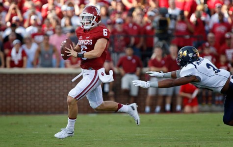 NORMAN, OK - SEPTEMBER 5: Quarterback Baker Mayfield #6 of the Oklahoma Sooners looks to throw under pressure from defensive lineman Jamal Marcus #34 of the Akron Zips September 5, 2015 at Gaylord Family-Oklahoma Memorial Stadium in Norman, Oklahoma. (Photo by Brett Deering/Getty Images)