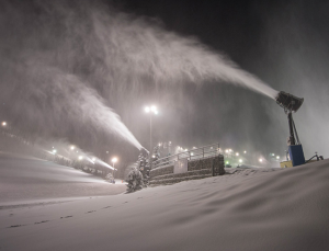 Previous season's snow being blown by the snow makers 