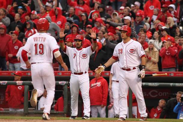 Joey Votta, Devin Mesoraco, and Eugenio Suarez celebrate at home plate during Opening Day