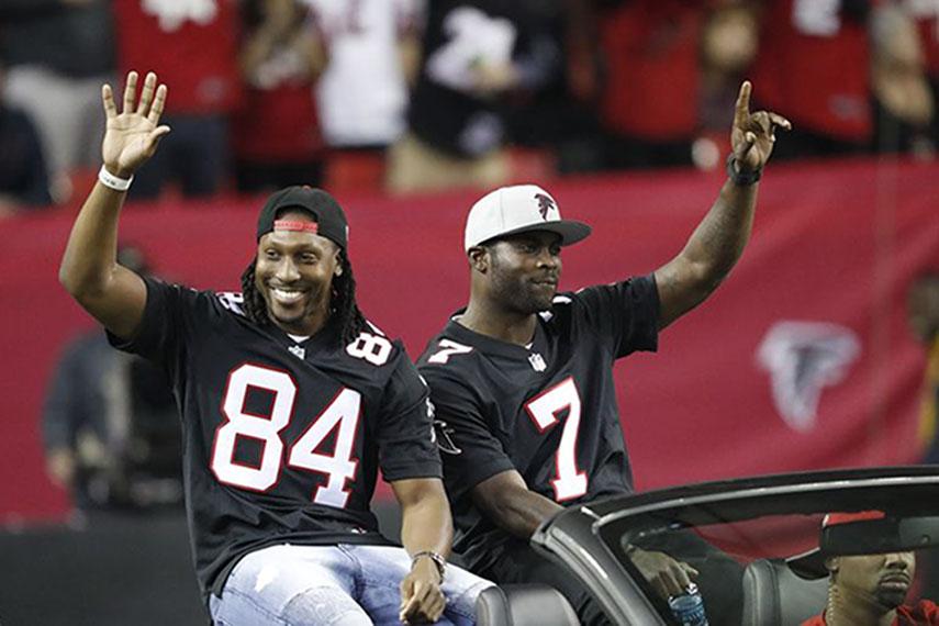 Vick rides in a Mustang, alongside Roddy White, in his return to the Georgia Dome in January 2017