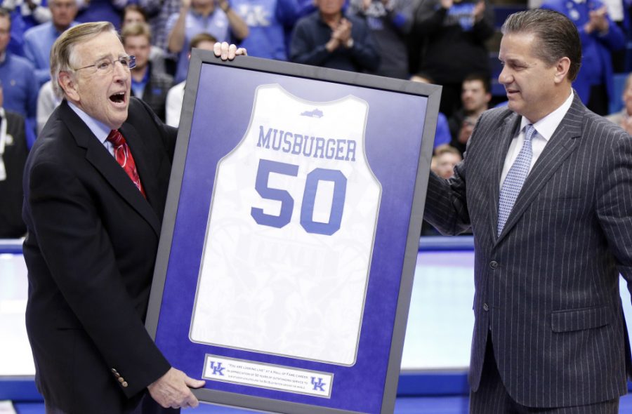 Veteran broadcaster Brent Musburger, left, is presented with a framed jersey in honor of his retirement by Kentucky head coach John Calipari prior to an NCAA college basketball game between Kentucky and Georgia, Tuesday, Jan. 31, 2017, in Lexington, Ky. The game marks Musburgers last broadcast. (AP Photo/James Crisp) ORG XMIT: KYJC106