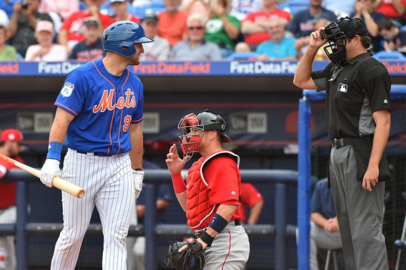 Tebow has a word with the home plate umpire after being rung up on a called third strike.