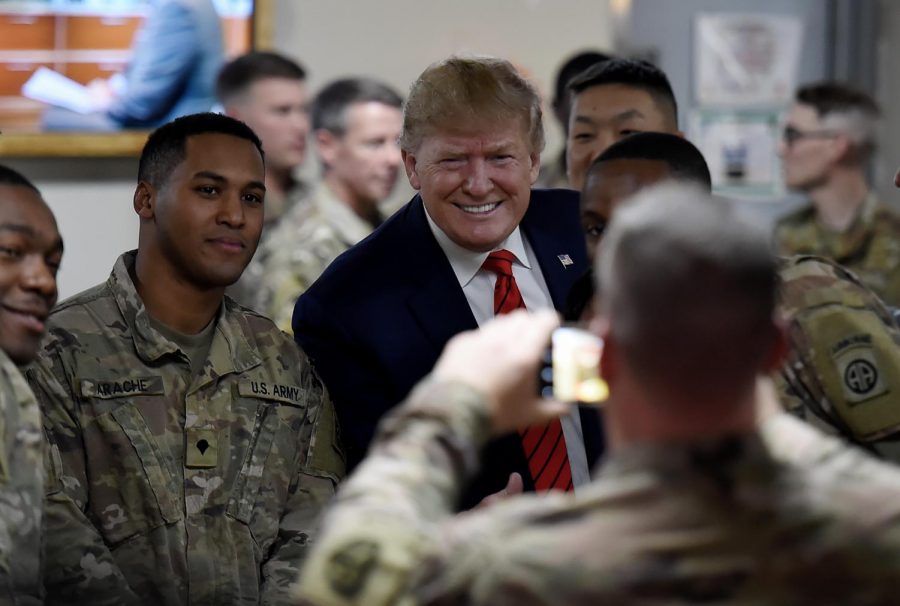 Pictured: Trump makes an unannounced visit to soldiers in Afghanistan last Thanksgiving.