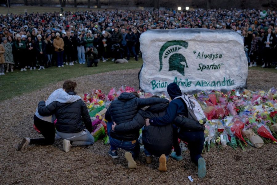 People mourning the loss of the tragic shooting that killed 3 students