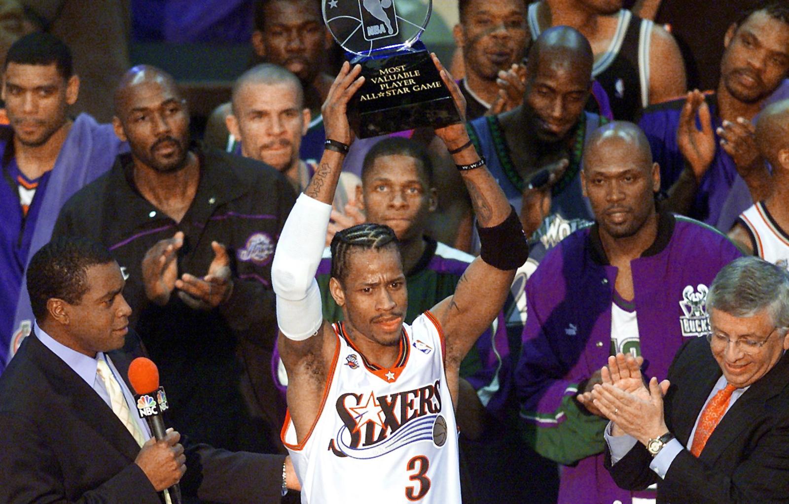 WASHINGTON, :  Philadelphia 76ers guard Allen Iverson (C) stands among his fellow NBA All-Stars and holds his MVP trophy for his performance in the 2001 NBA All-Star Game 11 February 2001 at the MCI Center in Washington, DC. Iverson scored 25 points and rallied the Eastern Conference from a 21-point fourth-quarter deficit to a dramatic 111-110 victory over the favored Western Conference in the 50th annual NBA All-Star Game. AFP PHOTO/Mario TAMA (Photo credit should read MARIO TAMA/AFP/Getty Images)